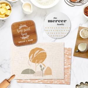 Kitchen decor in light, warm colors, including a pot holder, placemats, and a stone trivet