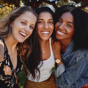 Three women smiling together