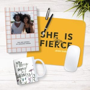 Flat lay image featuring a mug, mousepad, and notebook in an office setting