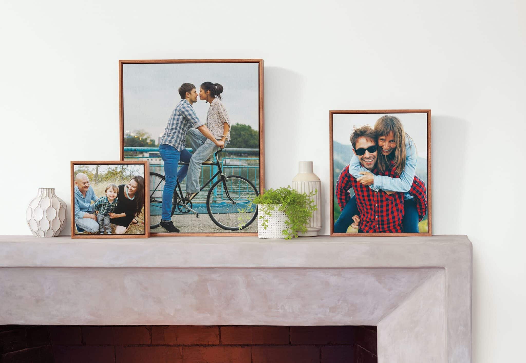 three framed canvas prints on a mantle